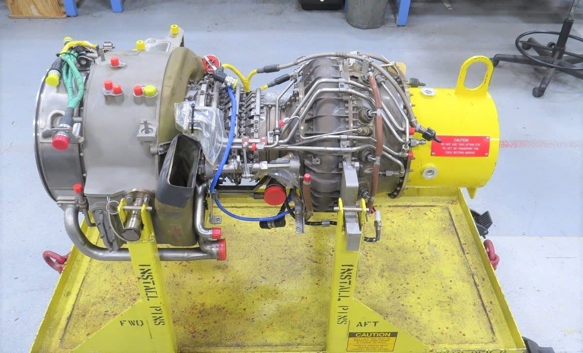 GE T700 cold-section module on an assembly stand, side view with compressor casing, fuel lines and harnesses